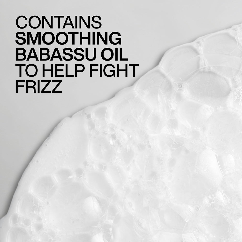 Shampoo working through wet hair to reduce humidity frizz.