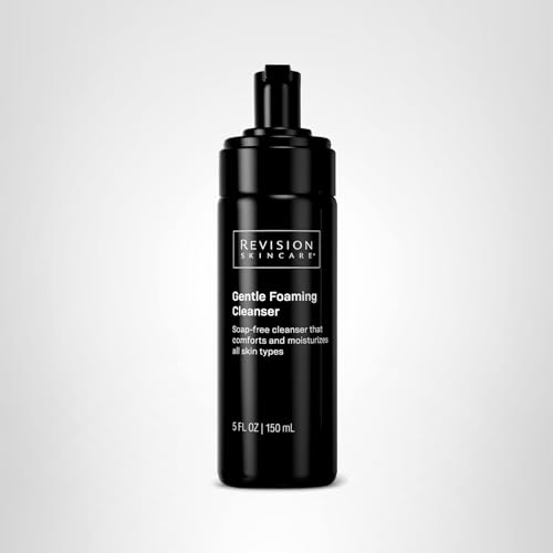 Bottle of Revision Skincare Gentle Foaming Cleanser beside a towel and mirror