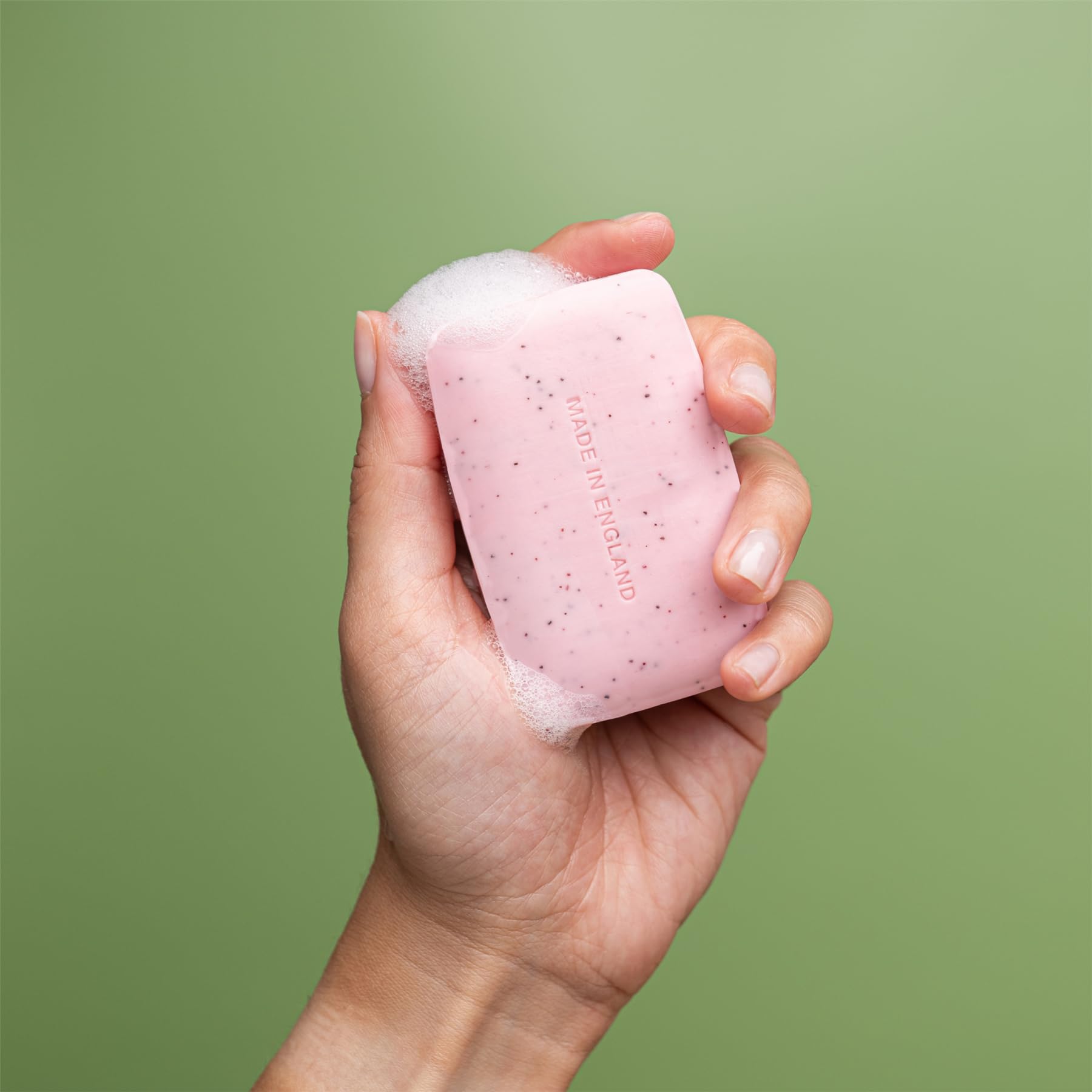 Pore-cleansing action shown by REVITALE Scrub Soap texture and apricot kernel particles.