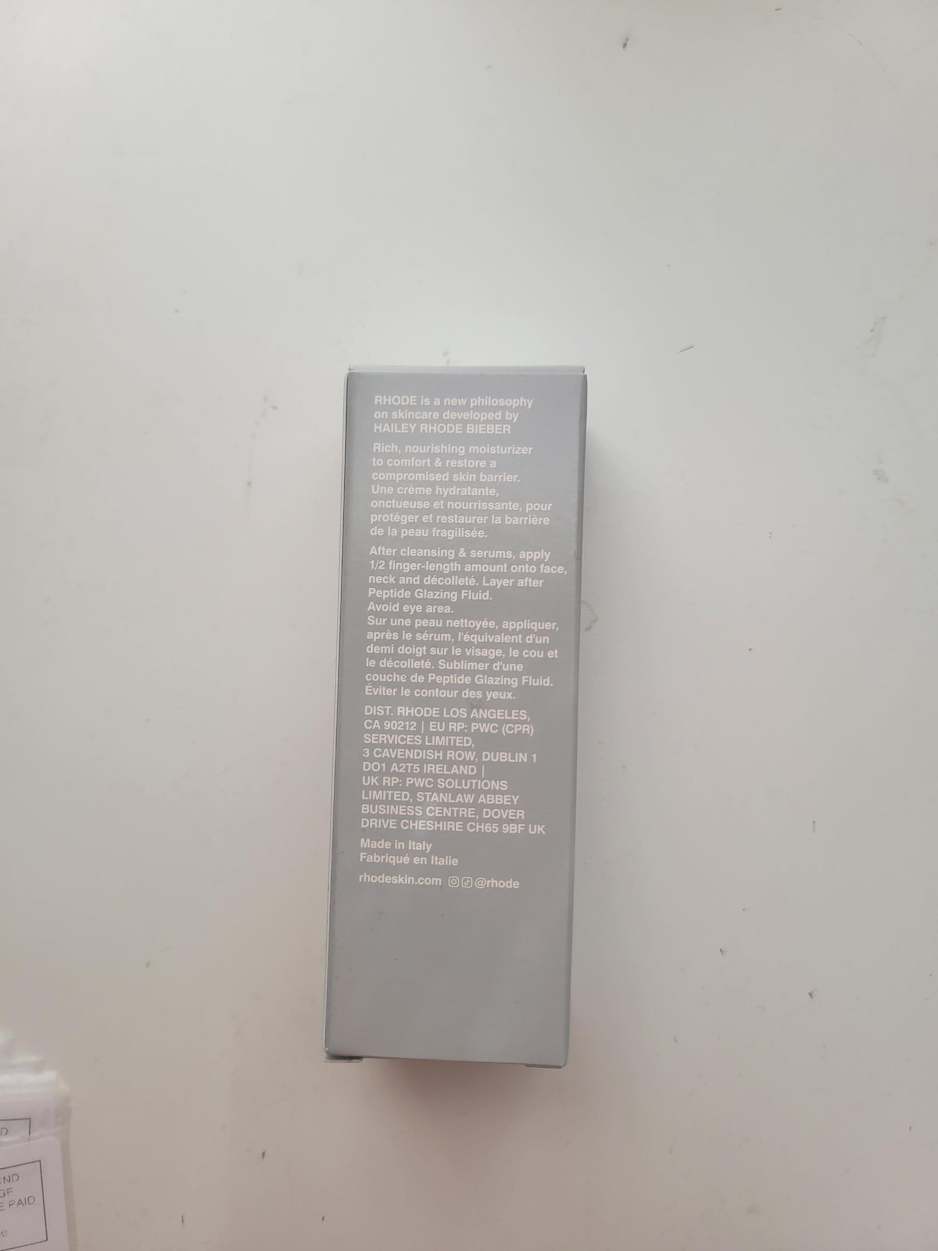 Rhode Barrier Restore Cream application on skin demonstrates gentle massage.