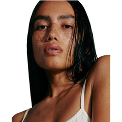 Rhode Salted Carmel gloss on lips delivering nourished, plump-looking lips.