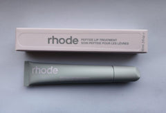 Rhode Watermelon Slice Lip Treatment bottle delivering hydration with a glossy finish.