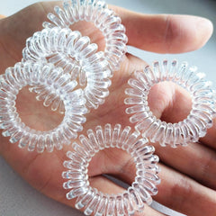 RN BEAUTY coletas espirales transparentes en cabello con sujeción suave.