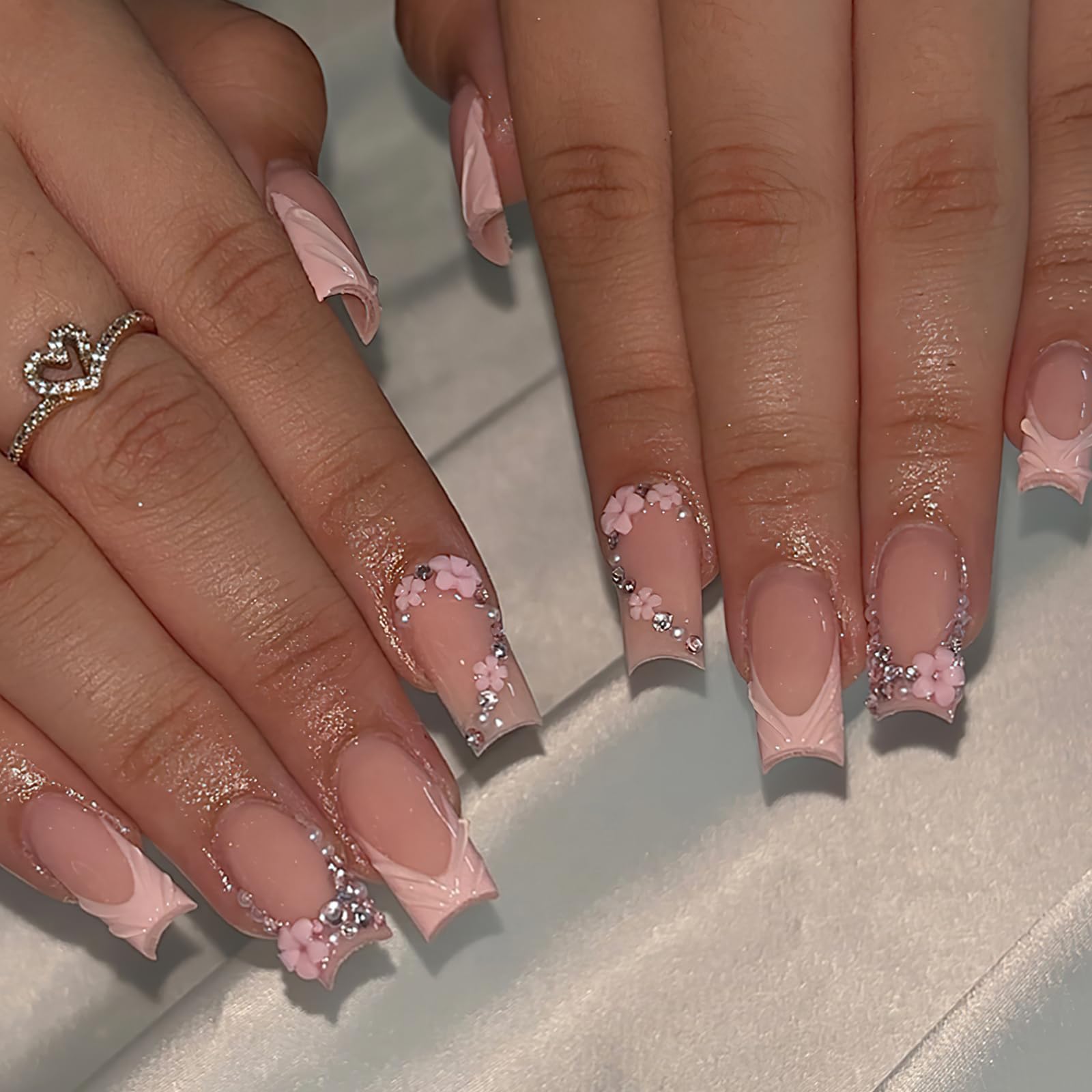 ROFIBUT pink French tip nails featuring embellishments for special occasions.