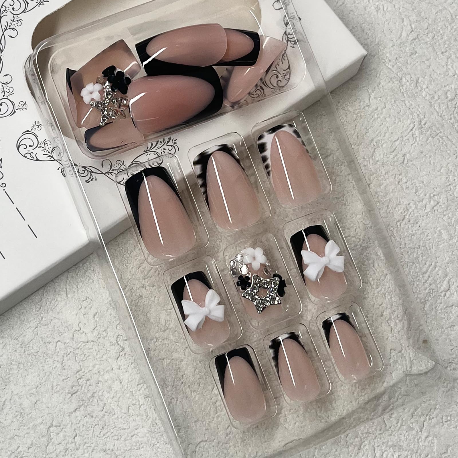 ROFIBUT zebra print nails with flower accents for playful styling.