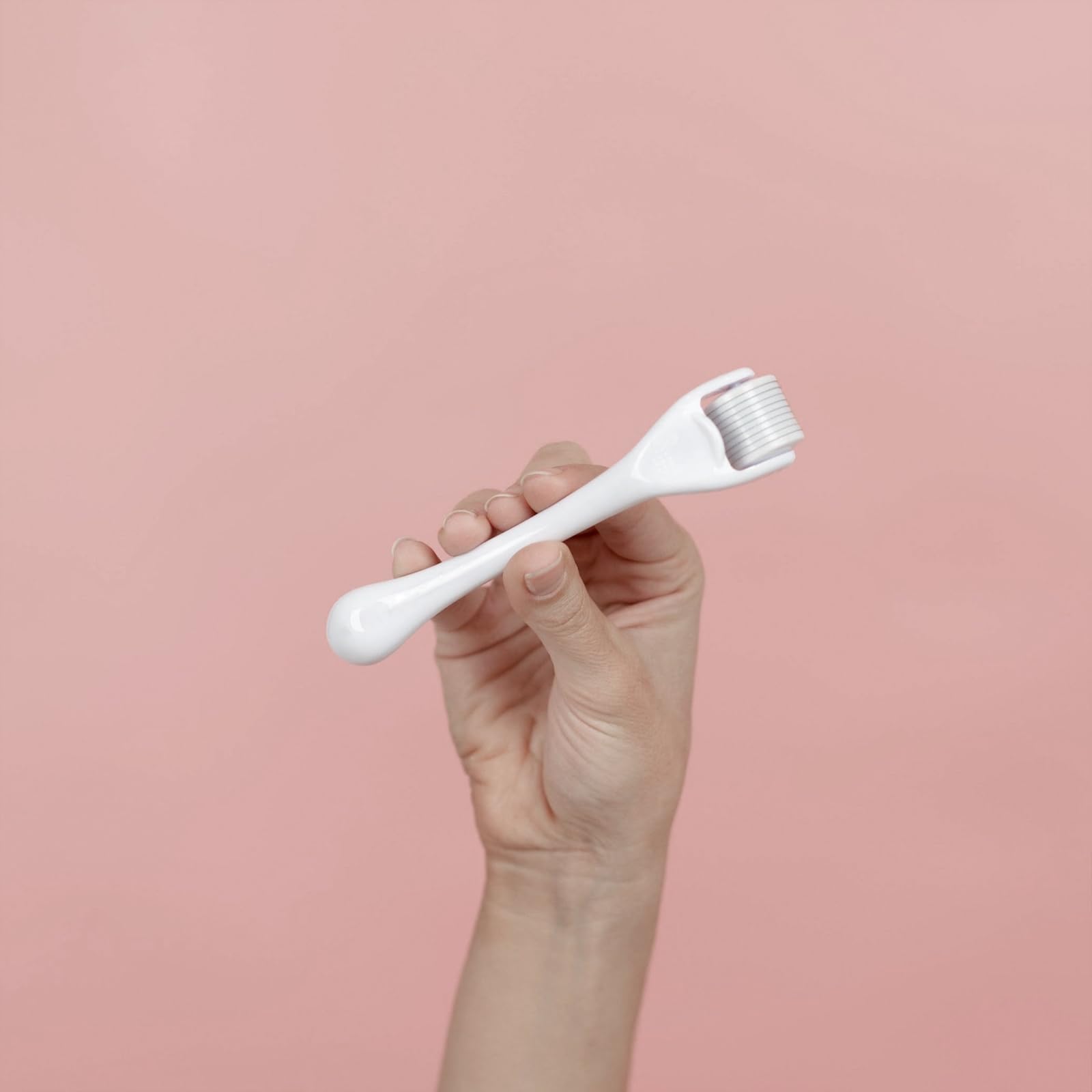 ROSELYNBOUTIQUE Derma Roller on the hairline area during use for even contact.
