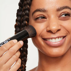 Saie Base Foundation Brush used with foundation for even application.