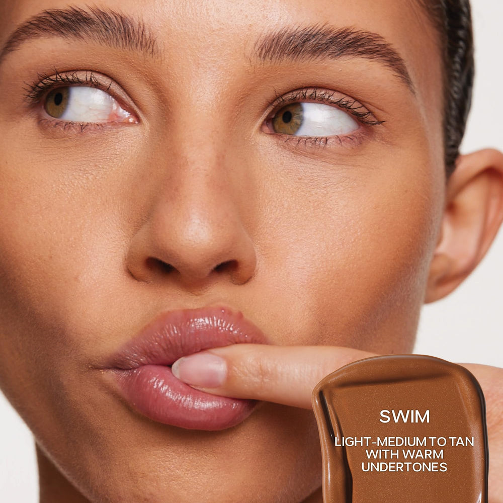 Saie Dew Bronze swirled on cheek for natural bronze definition.