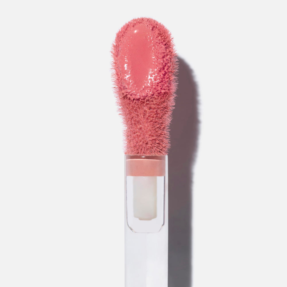 Swatch of Saie Dew Liquid Blush in Sweetie showing buildable color on cheek.