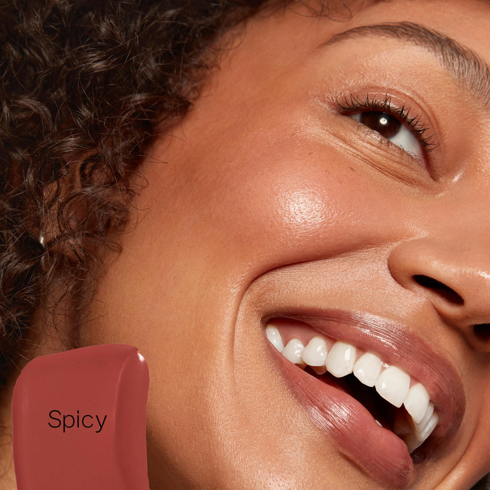 Saie Dew Liquid Blush Spicy arm swatch shows sheer to buildable color