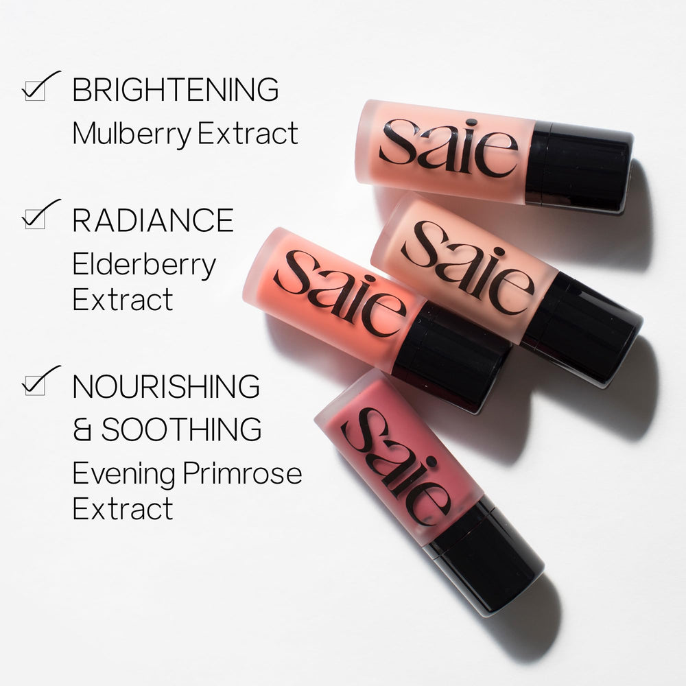 Saie Dew Liquid Blush swatches on cheek for blendable glow.