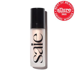 Pouring Saie Glowy Super Gel to create a dewy base glow.