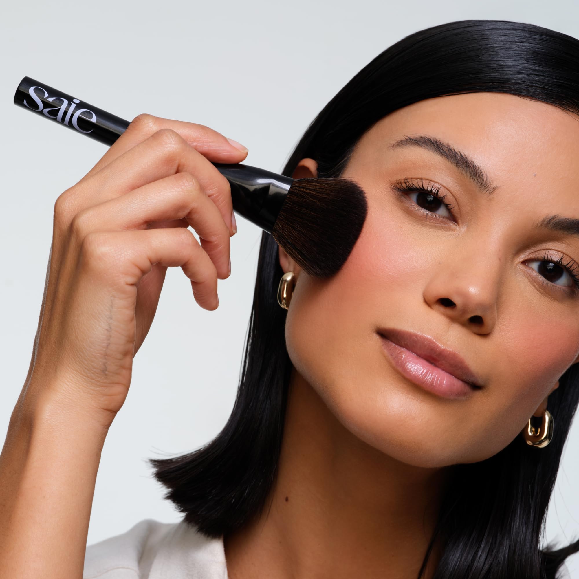 Saie Powder Blush Brush diffused powder application on cheeks for soft finish