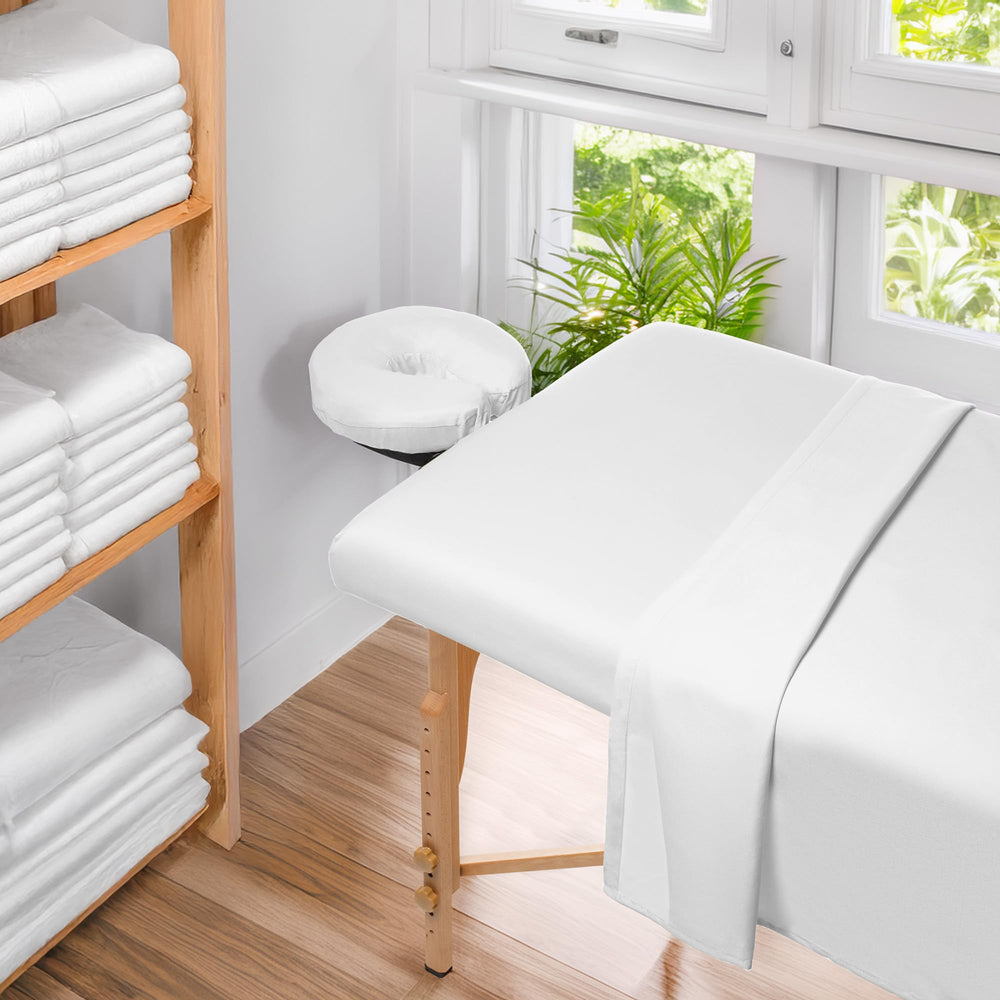 Saloniture therapy-room setup demonstrates clean, professional presentation with white linens.