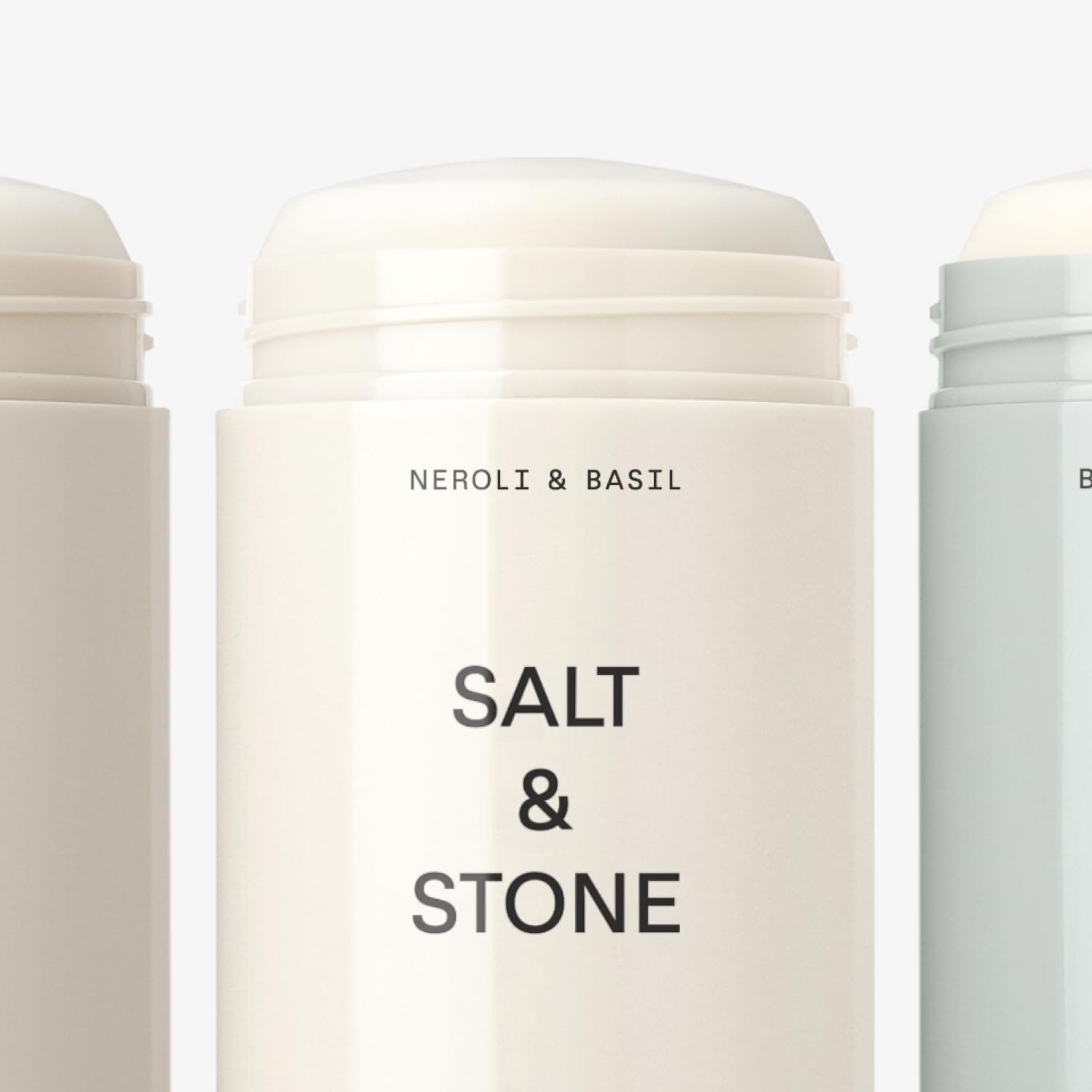 Salt & Stone Neroli & Basil scent bottle with crisp greenery.