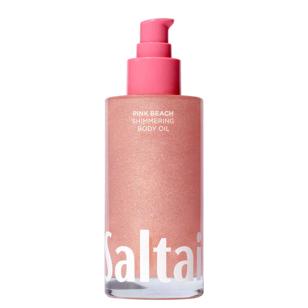 Saltair Shimmering Body Oil pink beach bottle pour for radiant, non-greasy hydration.