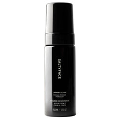 SALTYFACE tanning foam bottle demonstrates oil-free, fragrance-free formula for smooth application.