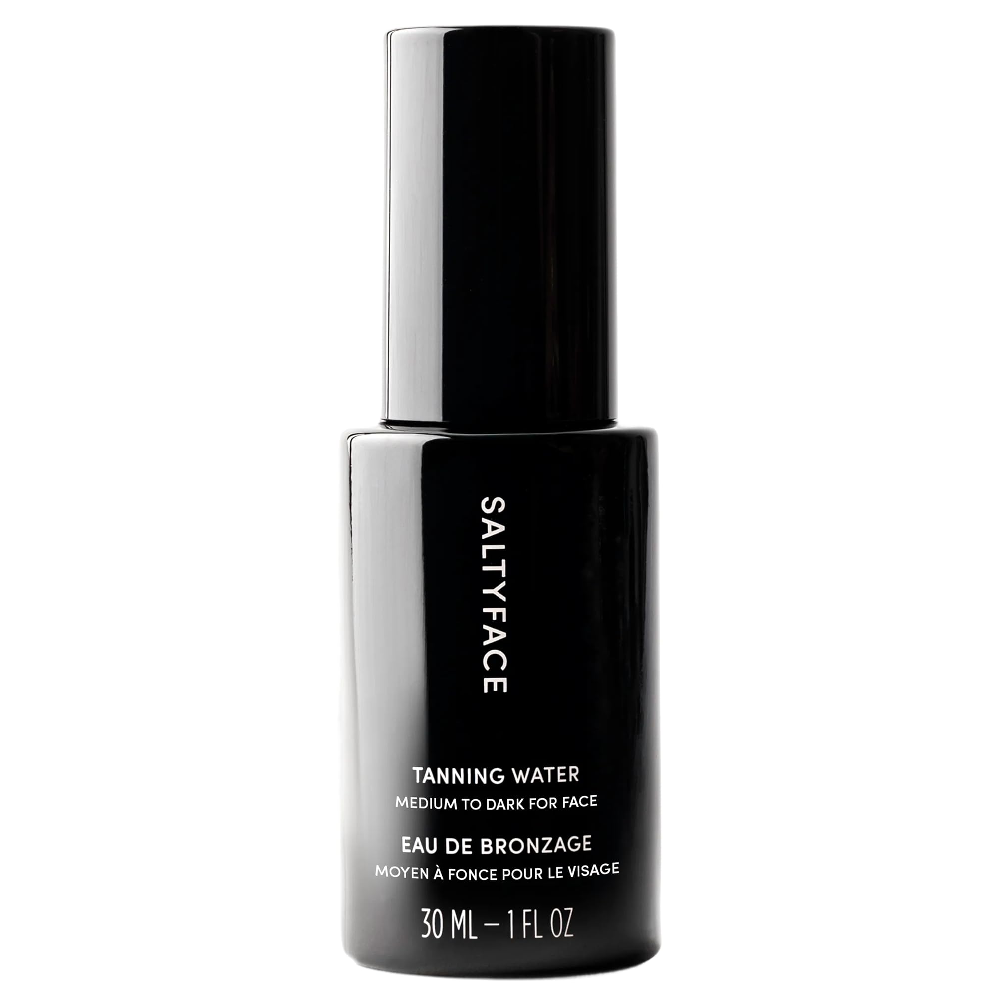 SaltyFace Tanning Water bottle closeup highlighting a clean, water-light formula for daily use