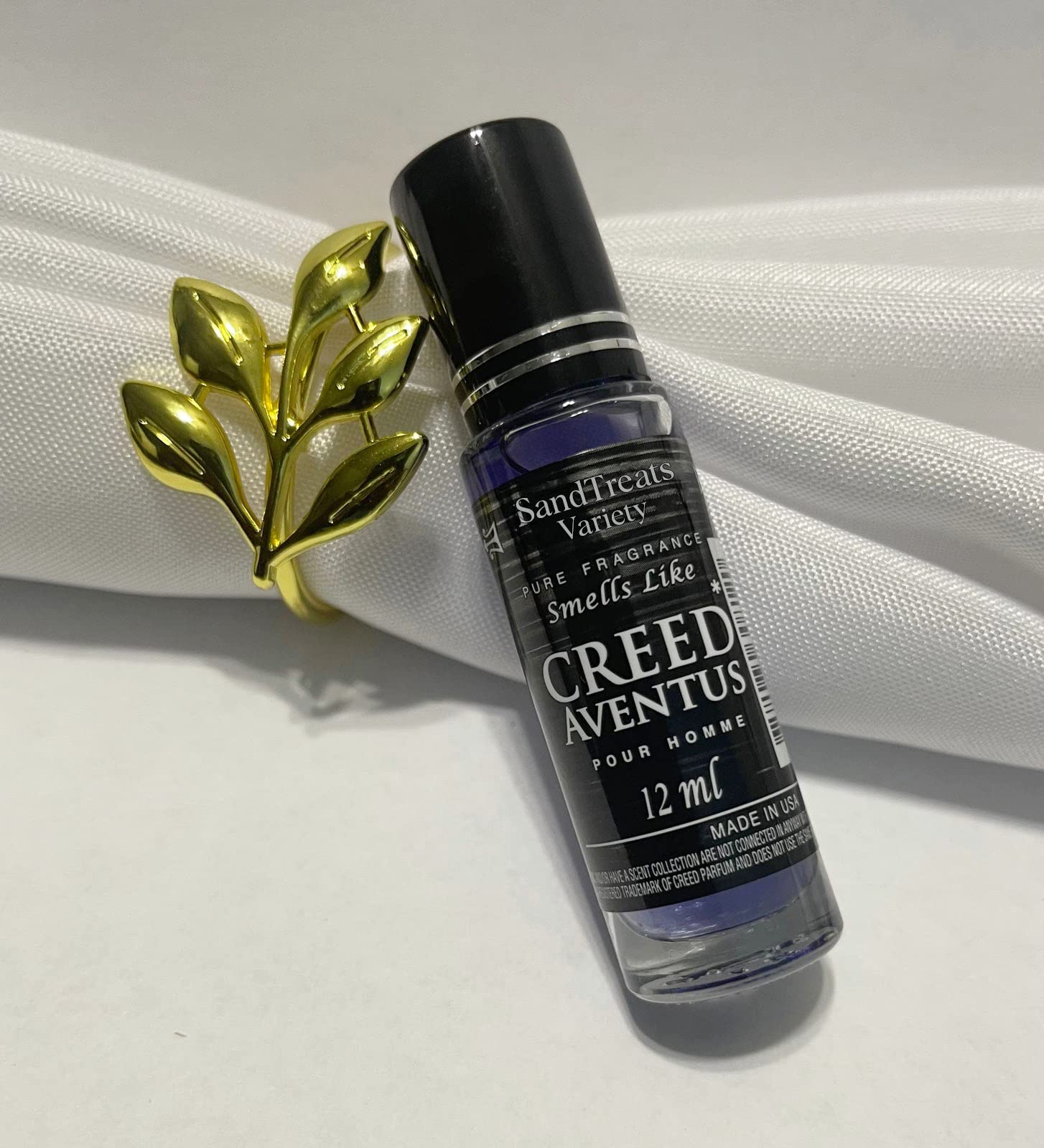 SandTreatsVariety Creed Aventus roll-on oil blends patchouli for depth and lasting appeal.