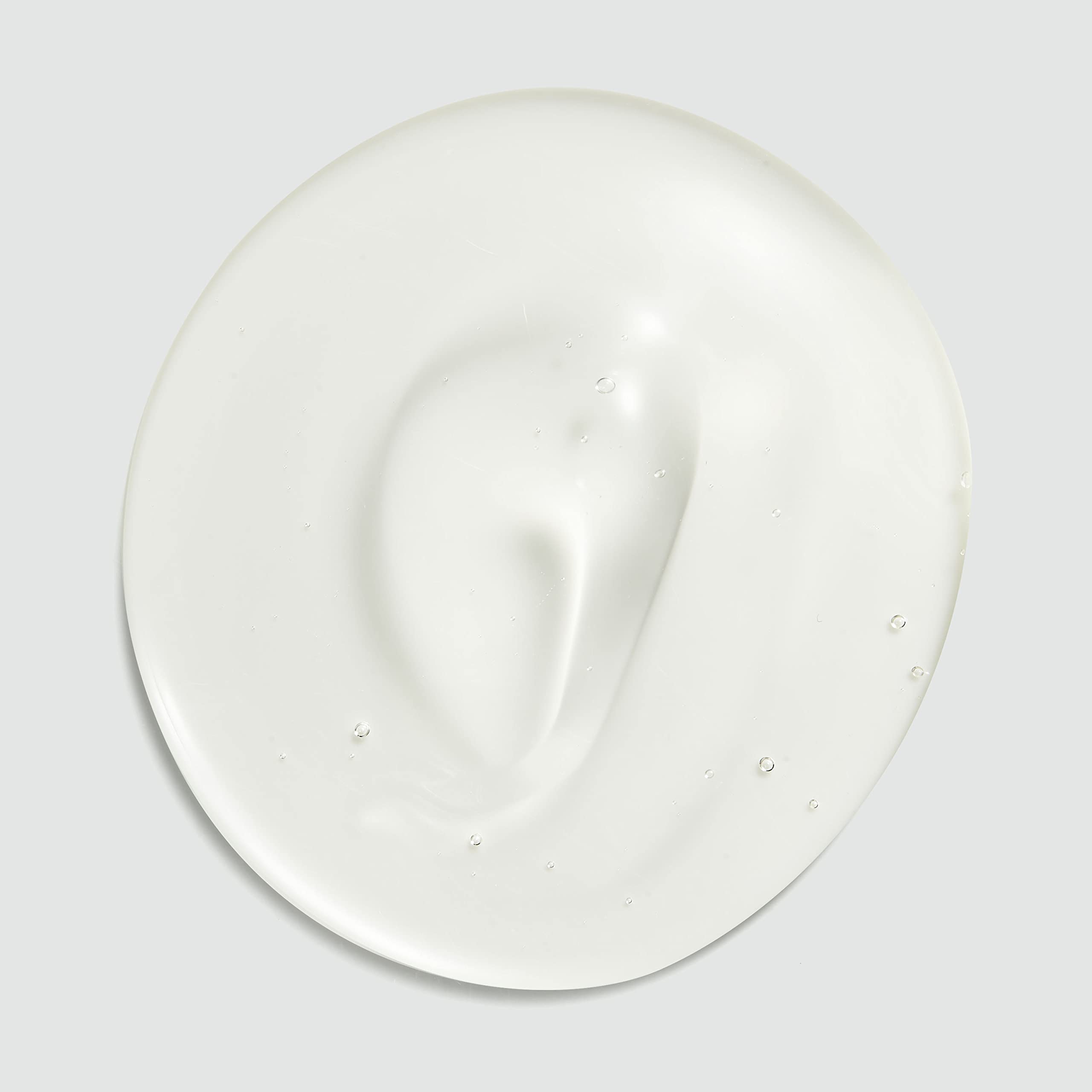 Sebastian Dark Oil Shampoo bottle on vanity with soft lighting, suggesting premium fragrance.