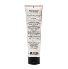 SEEN Blow-Out Creme being applied to hair for frizz control and shine.