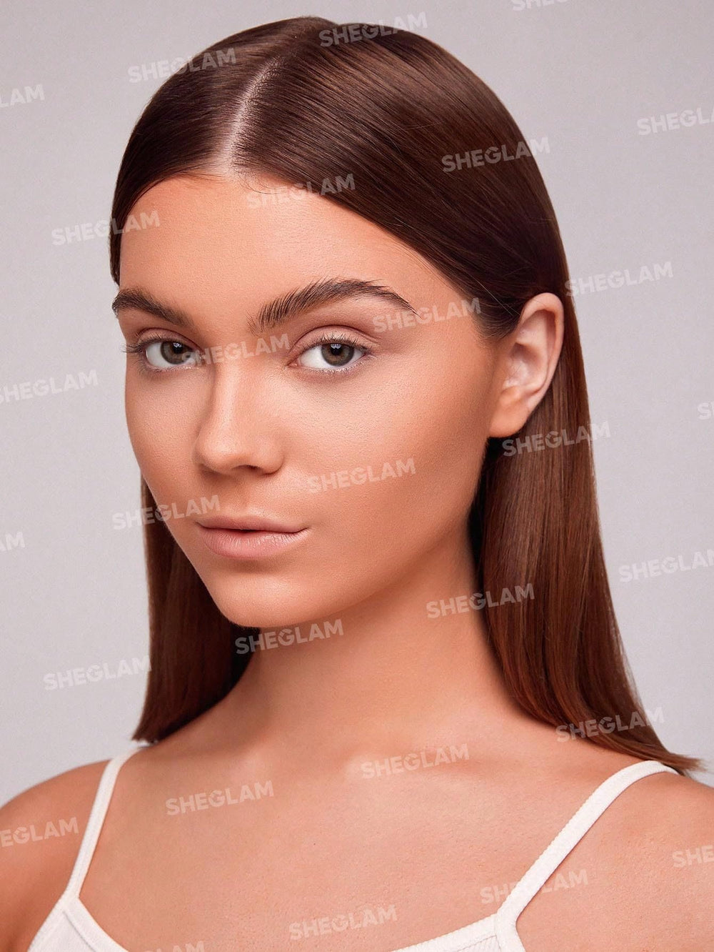 SHEGLAM Snatch 'n' Define contour stick applied to forehead and cheeks for precise shaping.