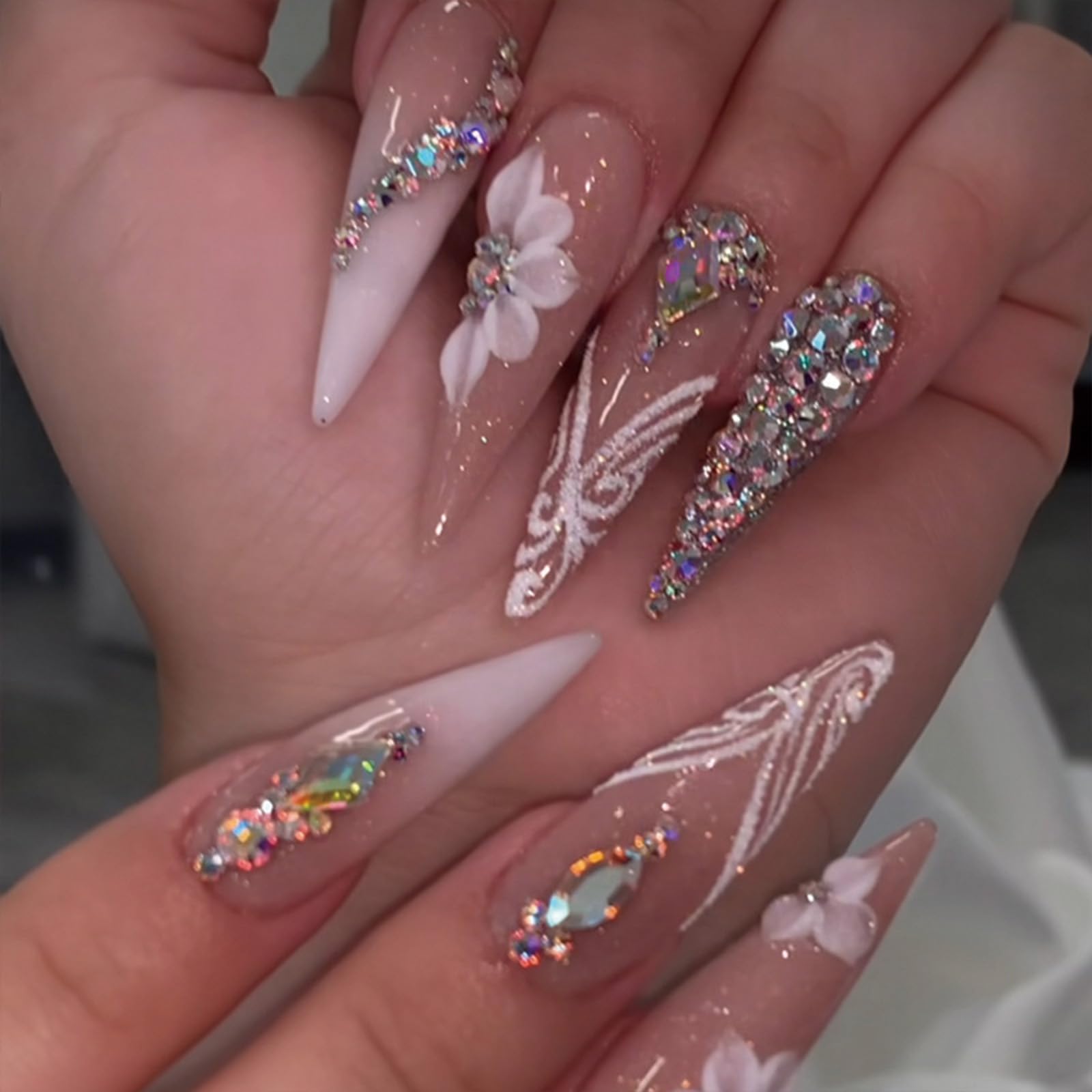 Long almond-shaped SINHOT nails for elegant, elongating fingertips.