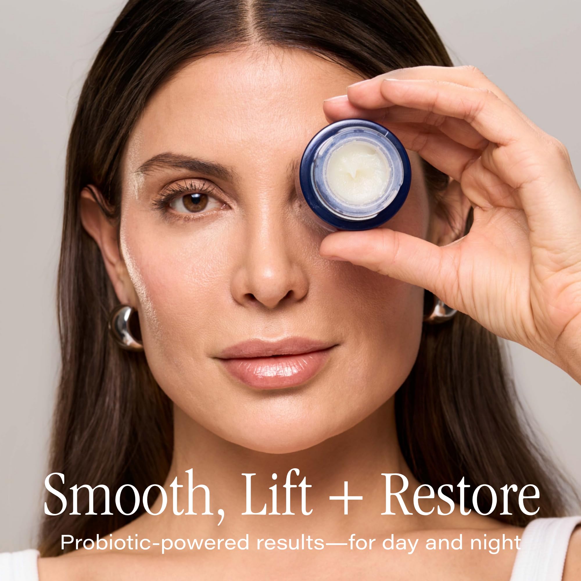 Hands applying SKINN balm around the eye area for night use