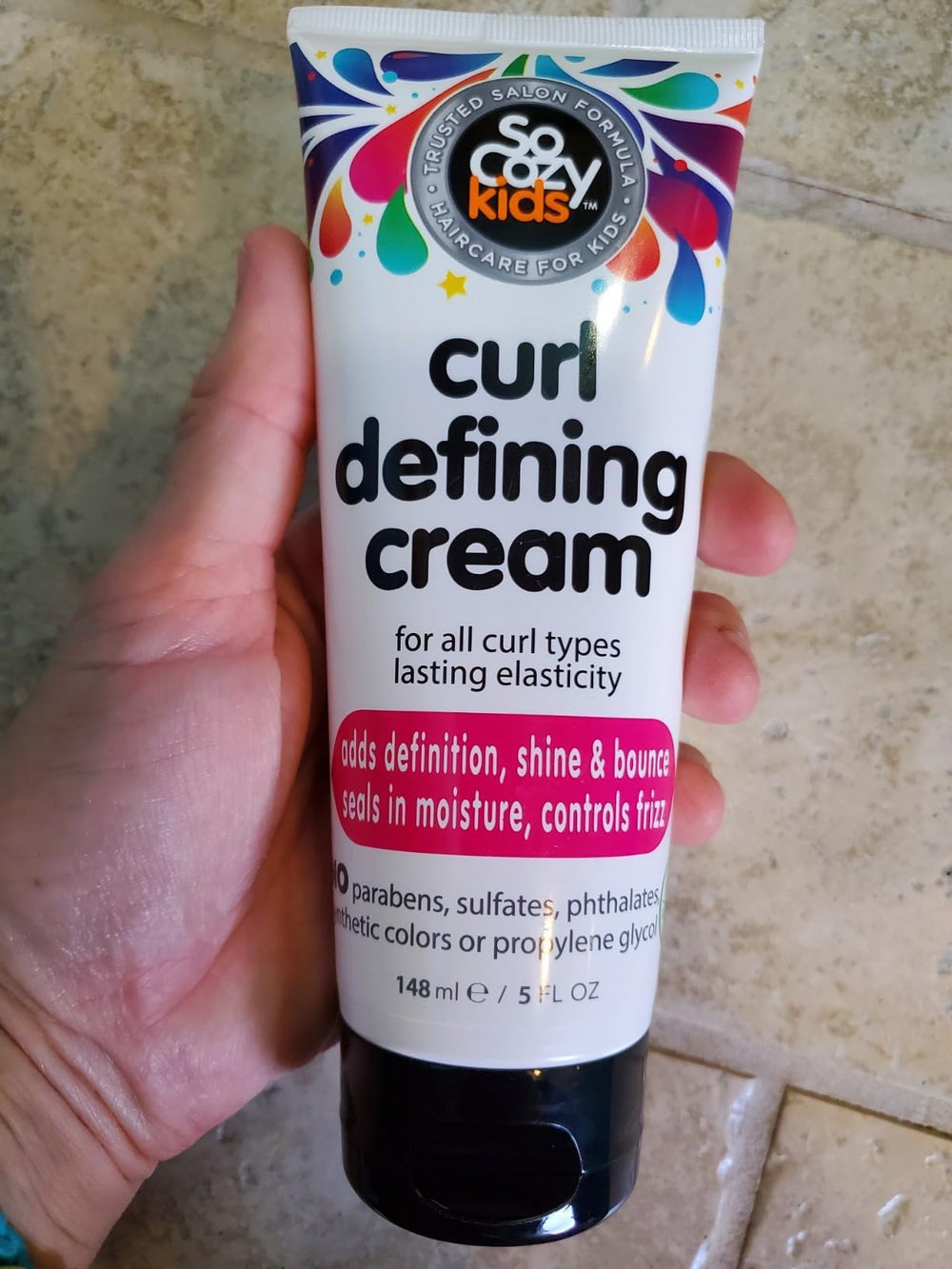 SoCozy Curl Defining Cream packaging highlights vitamins and oils benefits for kids' hair.