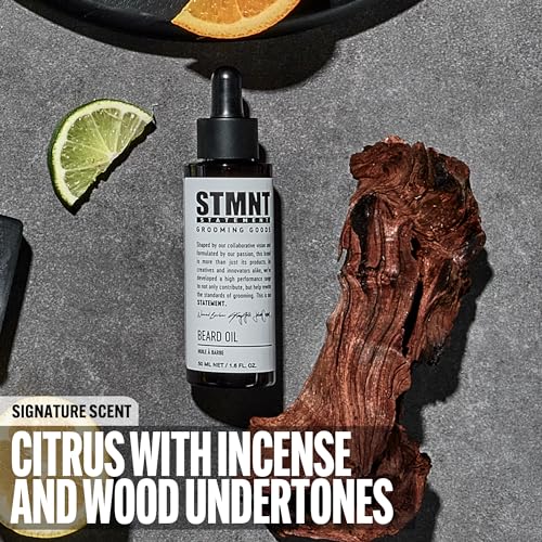Hands applying STMNT beard oil for a nourished, tame beard.