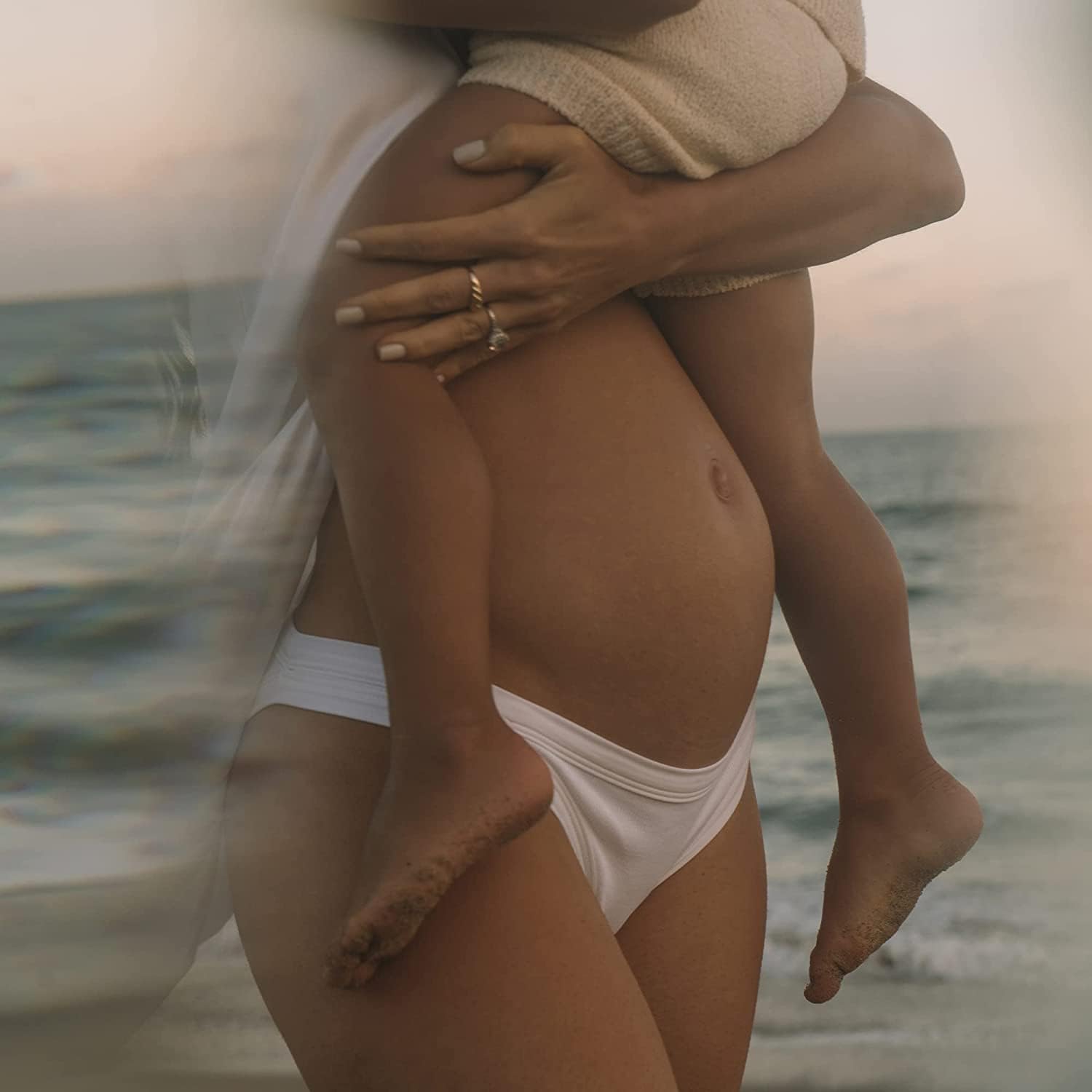 Summer Fridays Babymoon Belly Balm being massaged into skin demonstrates restorative hydration.