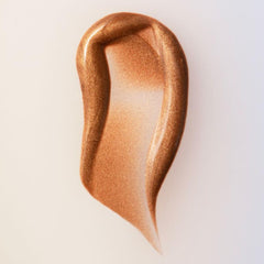 Close-up of the dropper releasing serum-like bronze formula