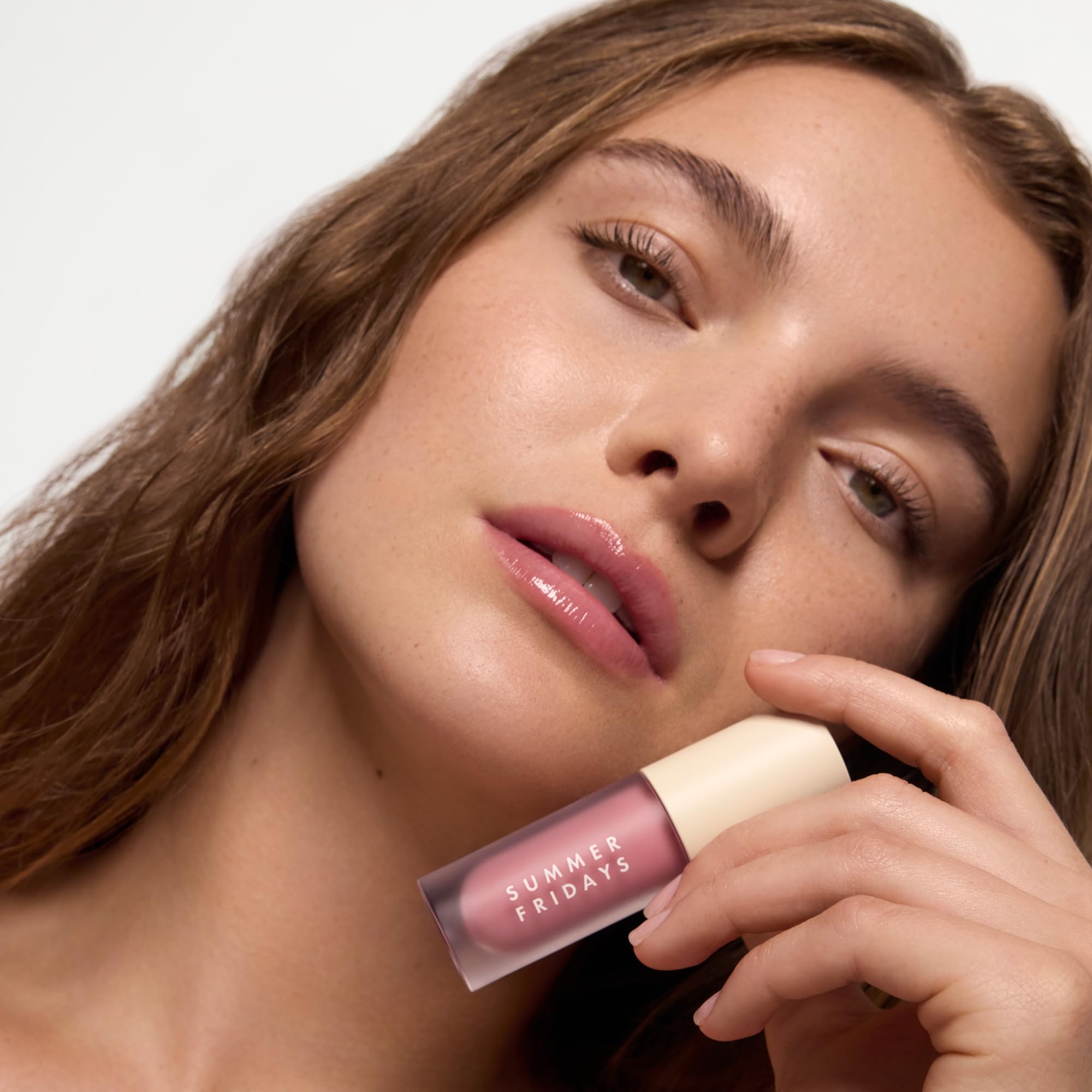 Summer Fridays Dream Lip Oil on lips delivers plush, non-sticky shine.