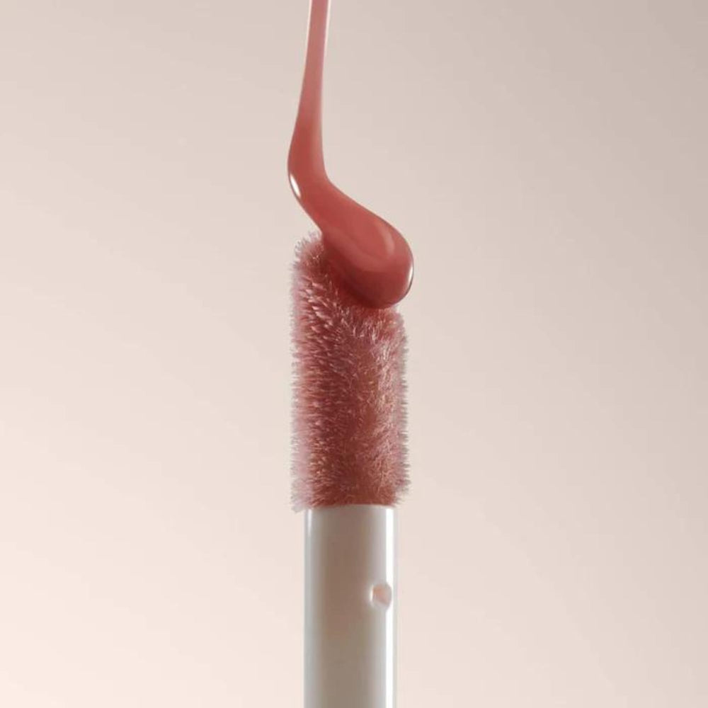 Summer Fridays Dream Lip Oil on bare lips for glow and moisture.