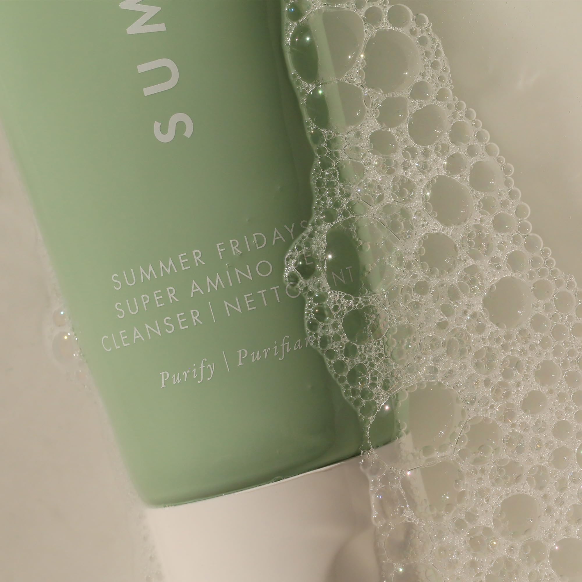 Summer Fridays Super Amino Gel Cleanser hand applying gentle circular massage on the face.