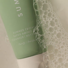 Summer Fridays Super Amino Gel Cleanser hand applying gentle circular massage on the face.