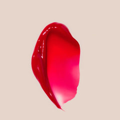 Cherry tint swatch shows sheer color and shine on lips.