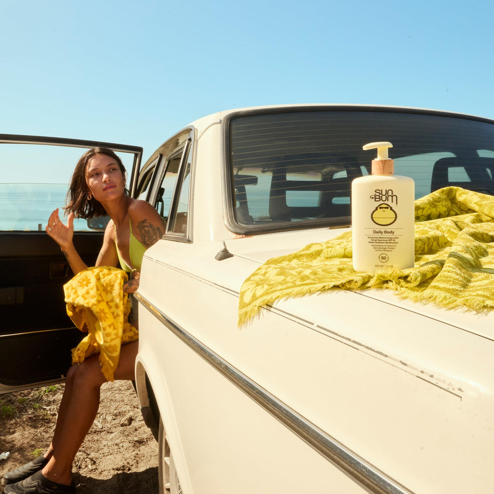8 oz Sun Bum Daily SPF 50 bottle shown with beach backdrop for everyday protection