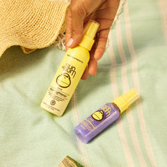 Sun Bum Lighten & Tone kit being sprayed on hair before sun exposure.