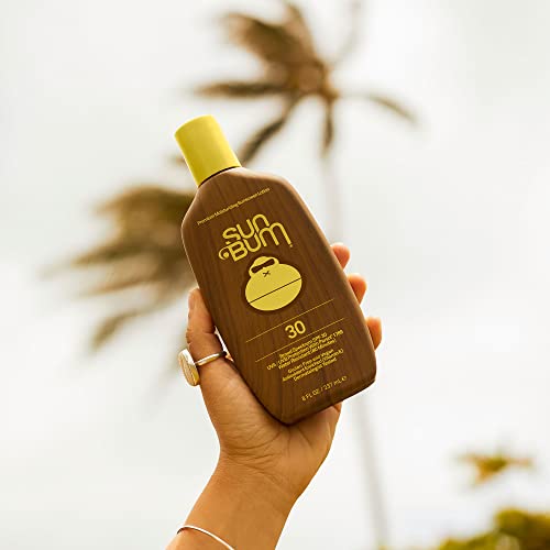 Applying Sun Bum Original SPF 30 sunscreen lotion to skin for protection.