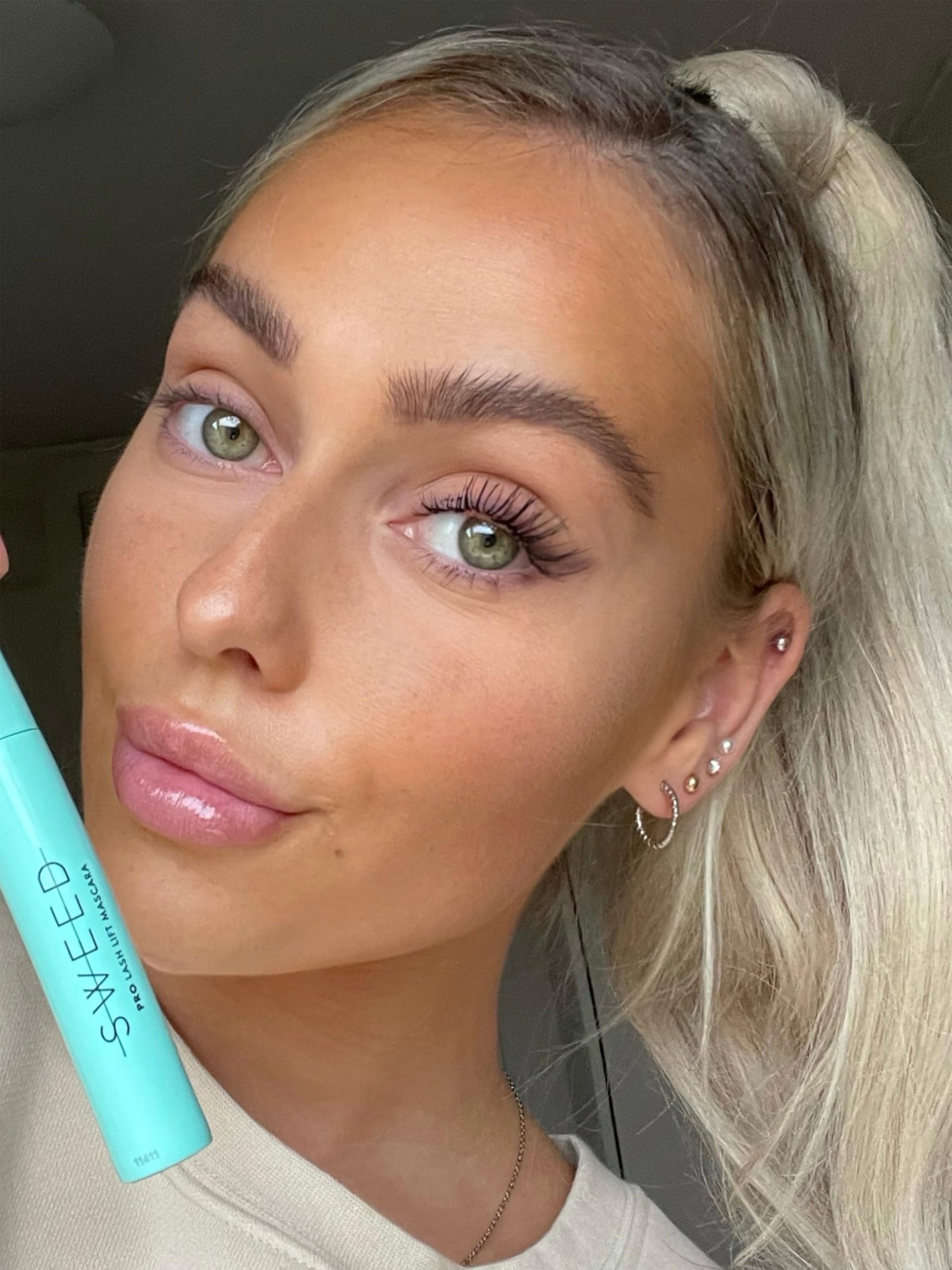 SWEED Lash Lift Mascara wand applying to lashes for dramatic length and lift