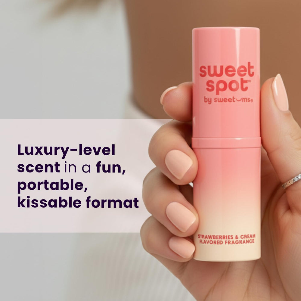 Sweetums SweetSpot travel-stick in hand for portable fragrance on the go