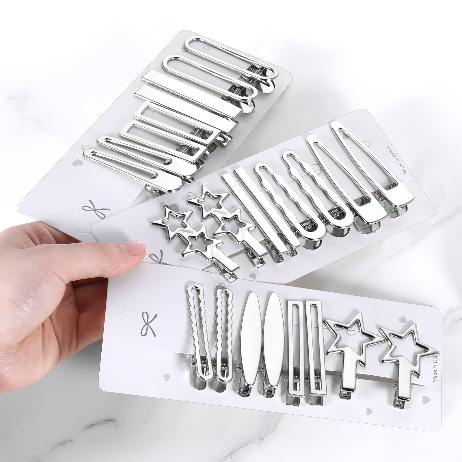Clip estrella plateado SynHHergyx para looks audaces y duraderos.