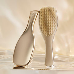 Chrome finish detangler reduces tugging while detangling straight to curly hair.