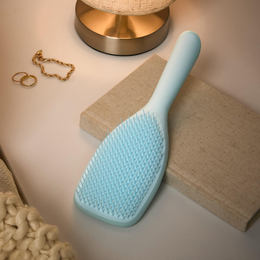 Tangle Teezer two-tier teeth detangle and smooth in one pass.