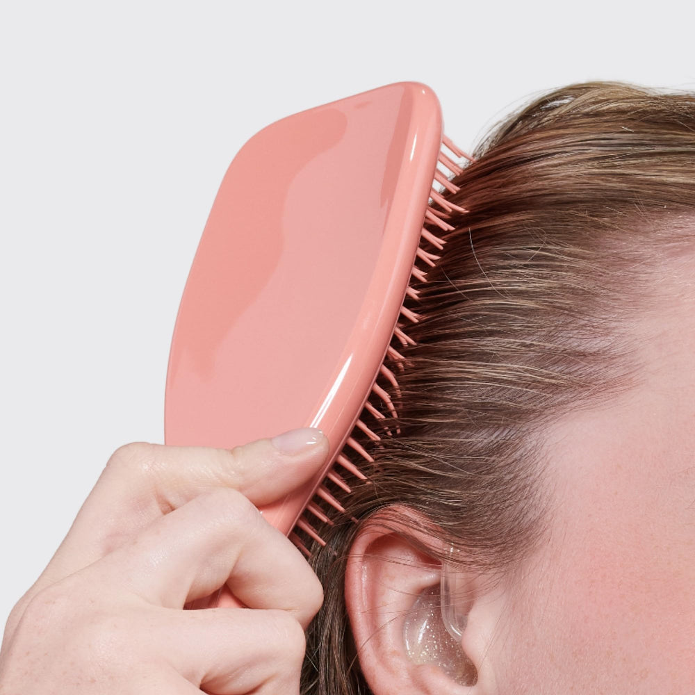 Tangle Teezer in use during styling session for smoother finishes.