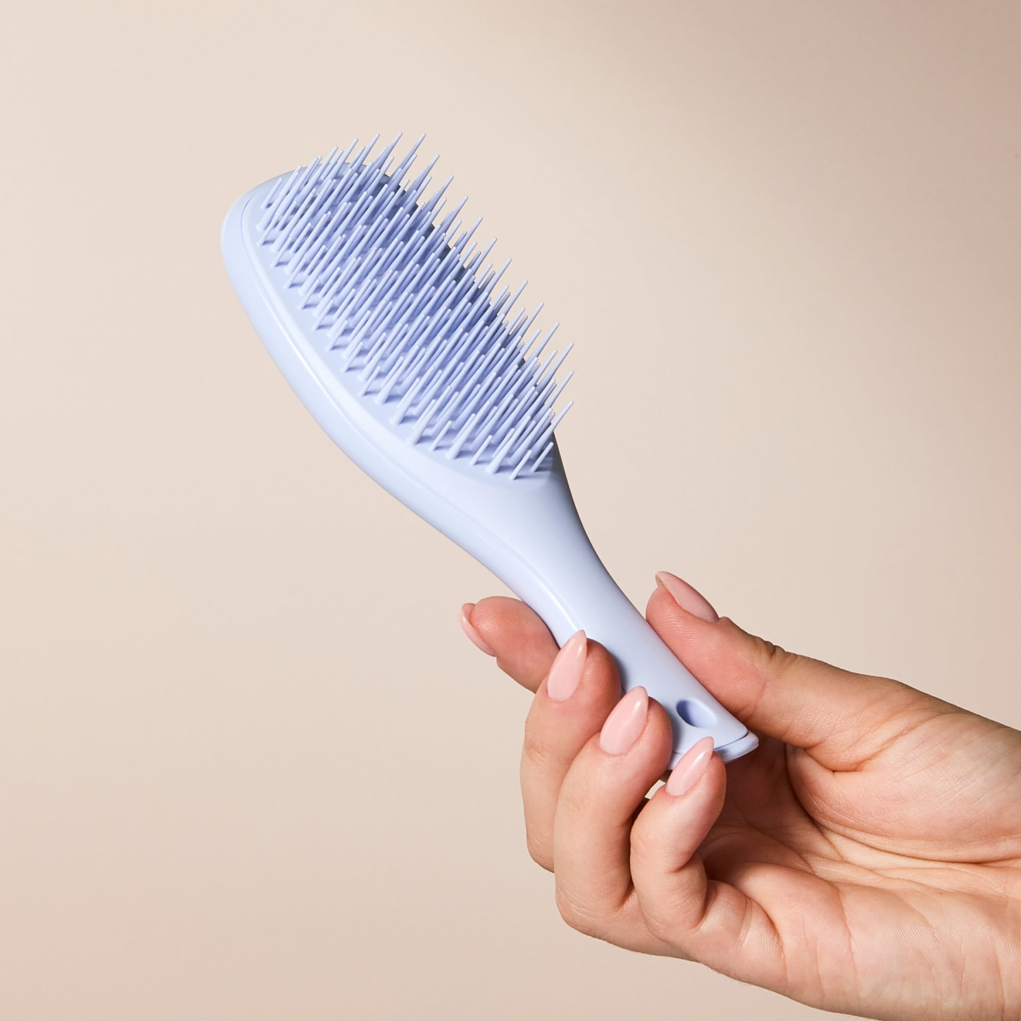 Tangle Teezer soft teeth glide through straight to wavy hair for smoother results.