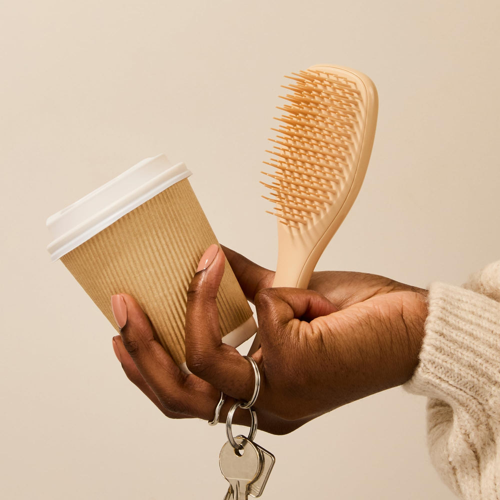 Tangle Teezer Ultimate Detangler sits in a purse for on-the-go use