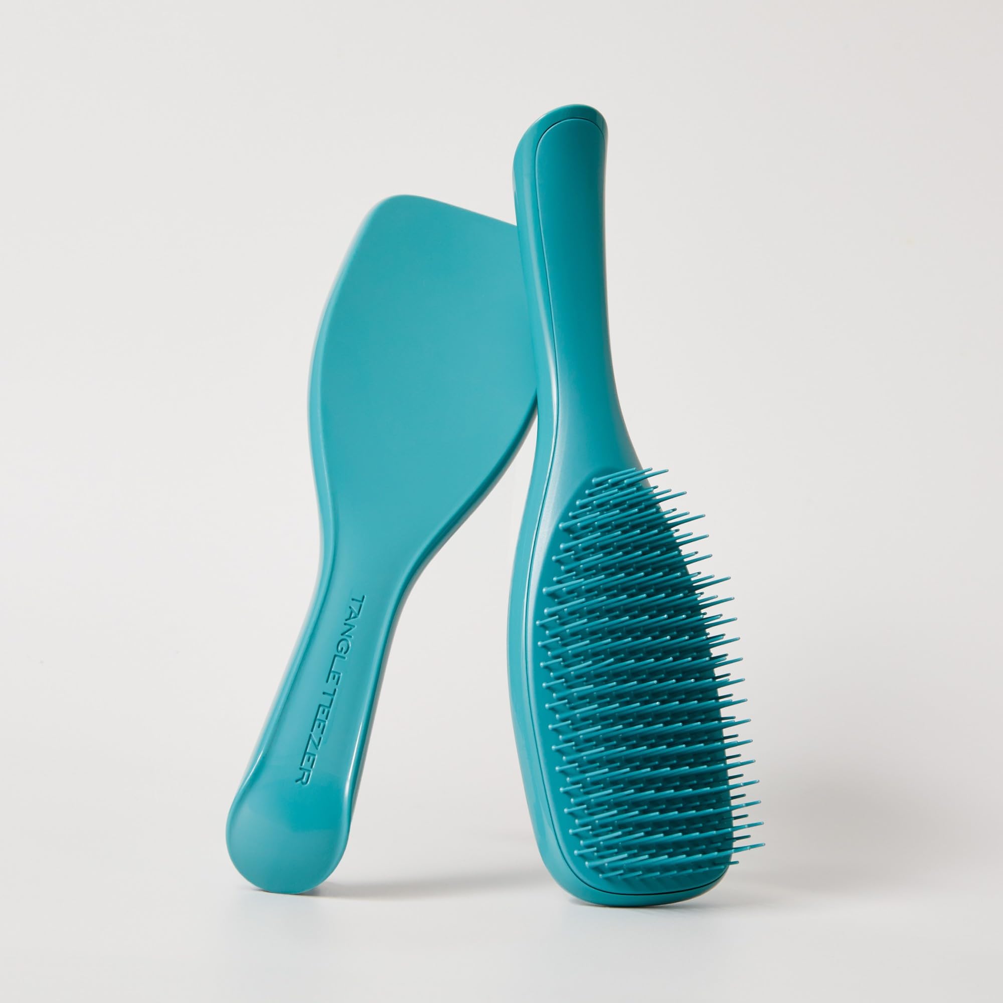 Tangle Teezer Ultimate Detangler demonstrates frizz-free styling.