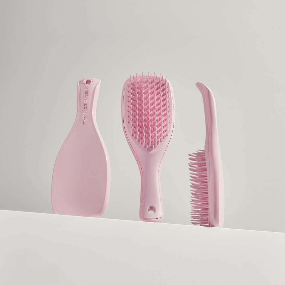 Tangle Teezer Ultimate Detangler reduces breakage with careful detangling of long hair.